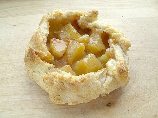 a piece of flaky, apple crostada