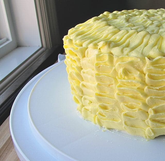 Ruffled Lemon Cake on a white cake holder 