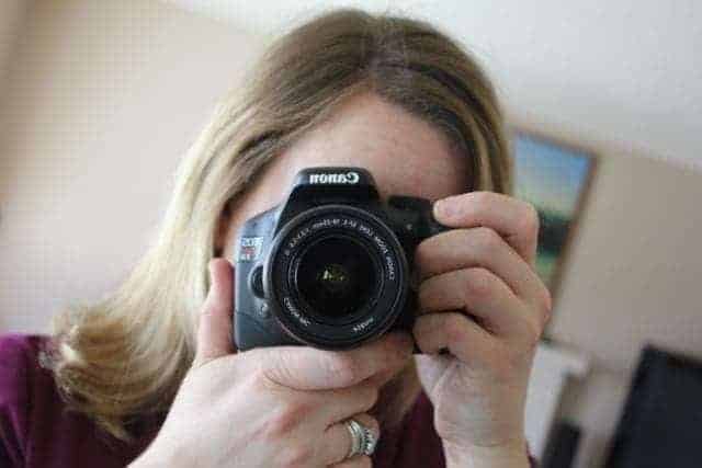 woman taking picture in front of mirror