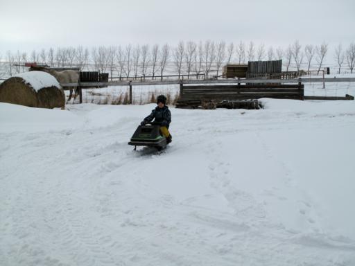 young boy riding his skidoo