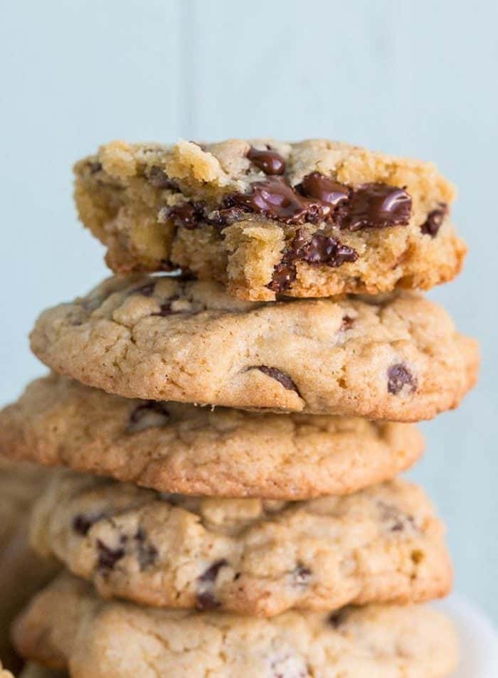 close up stack of Thick and Chewy Chocolate Chip Cookie in jade blue background