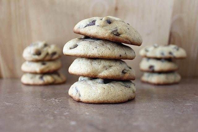 Stacks of Soft and Cakey Chocolate Chip Cookies on Wood Background