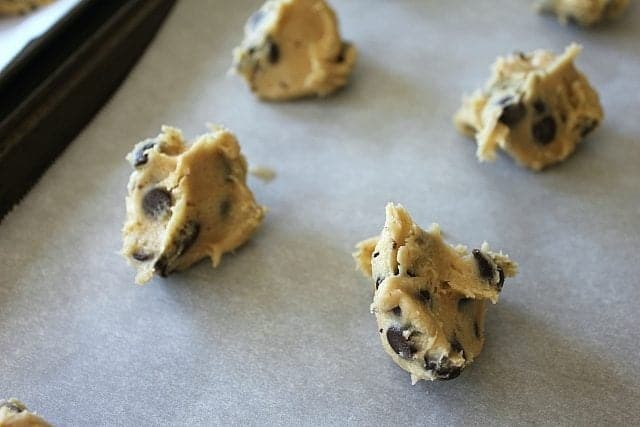chocolate chip cookie dough on parchment paper lined in baking sheet