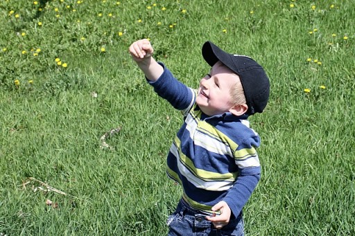 little boy so glad running after bubbles