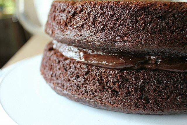 close up of Peanut Butter Cup Ganache in the middle of chocolate cake layer