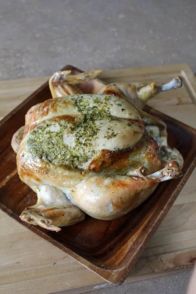 close up Roasted Chicken with Lemon Cilantro in a wood tray