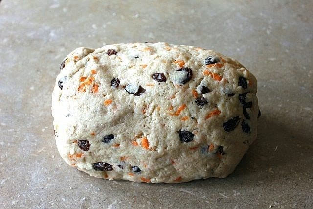 Rolled dough of Carrot Cake Scones like a stumpy log 