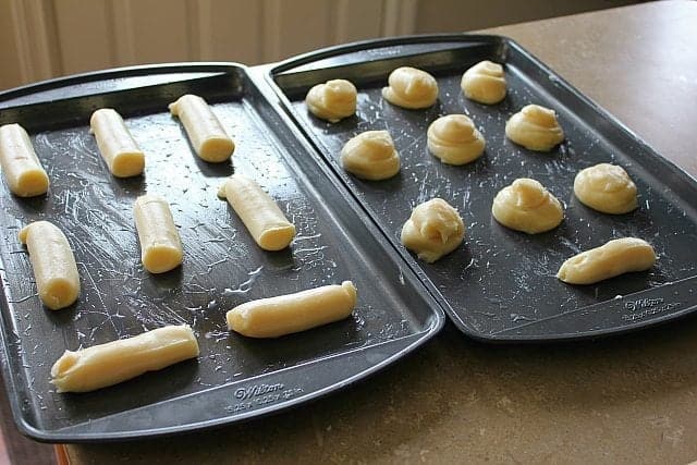 Pastry mixture on baking sheets in cut in Eclairs shapes