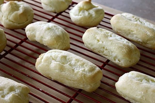  red cooling rack with Choux Pastry Baked into Eclair Shapes