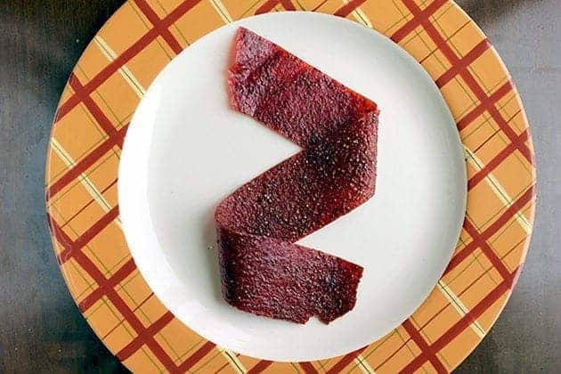 Rhubarb Strawberry Fruit Leather in a middle of a plate with orange design