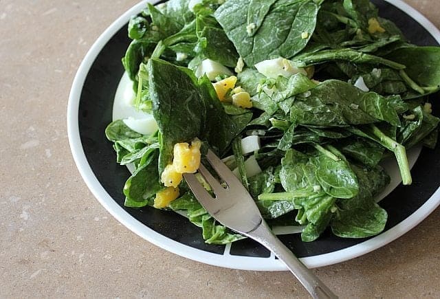 Egg, Almond & Spinach Salad in a bowl with a fork in it