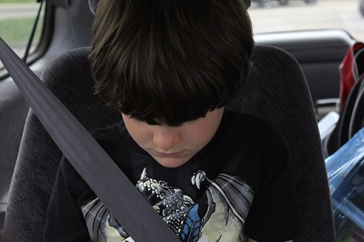 boy sitting in the car with heads down
