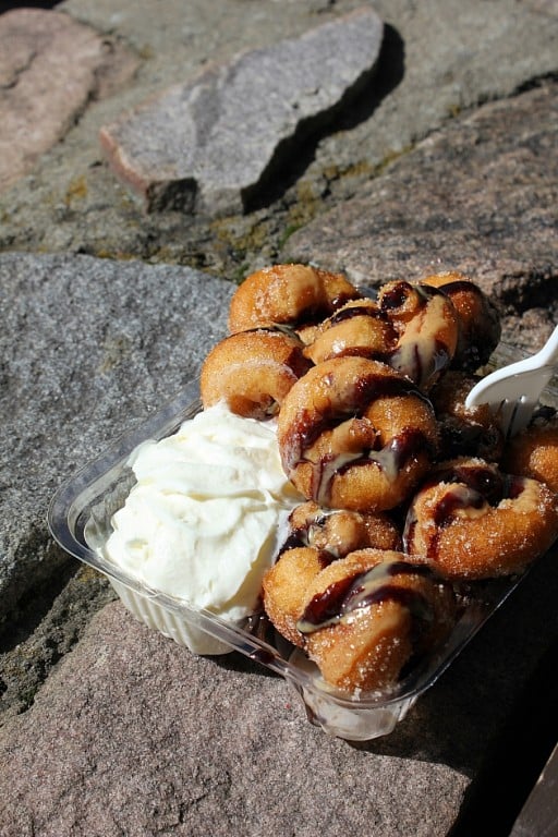 Chocolate sauce, peanut butter and whipped cream over mini donuts