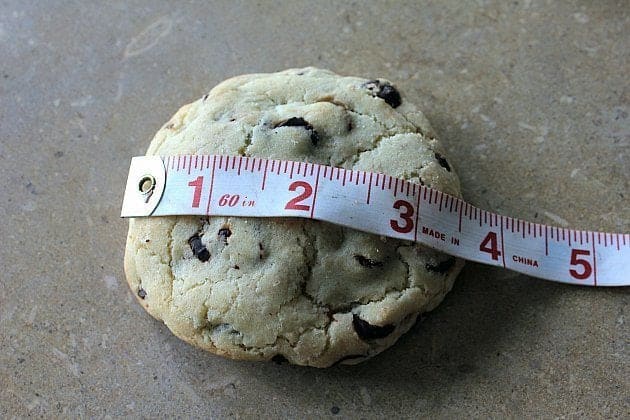 measuring the baked chocolate chip cookie using tape measure