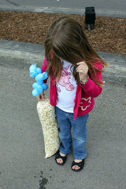 little girl looking at her bag of kettle corn