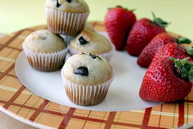 white plate with Mini Muffins and fresh strawberries