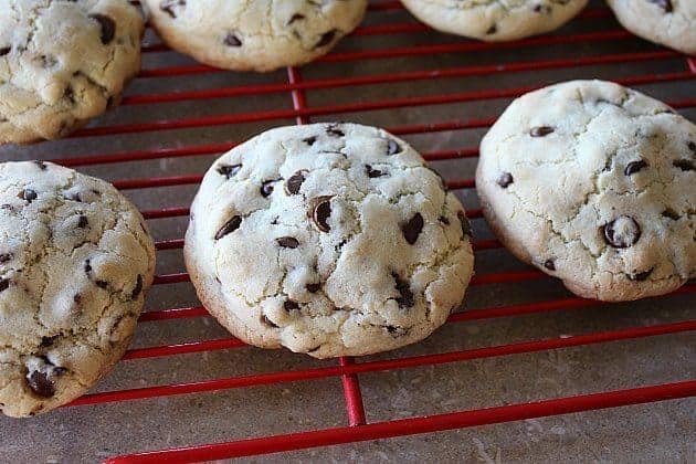 large chocolate chip cookies on red cooling rack