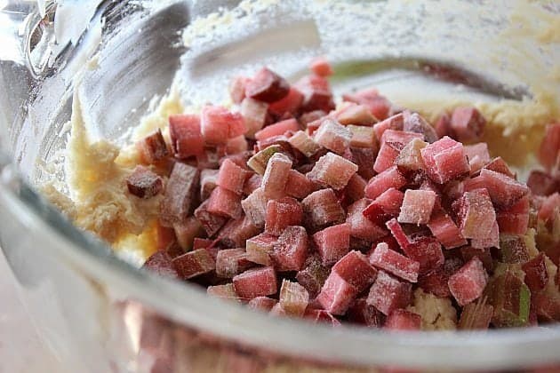 adding in chopped rhubarb that has been dusted in flour