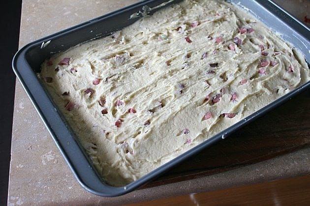 Batter spread over top of the strawberry and rhubarb mixture in a baking pan