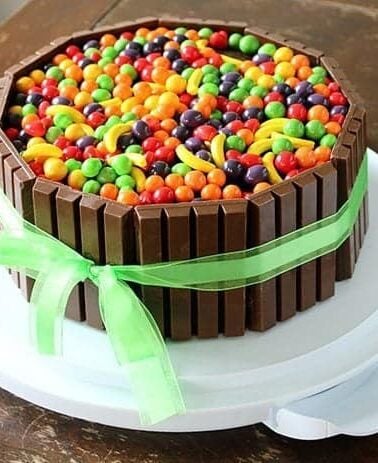 Willy Wonka colorful Cake with KitKat bars and green ribbon