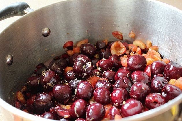 large stockpot with combined cherries, lemon juice and rind
