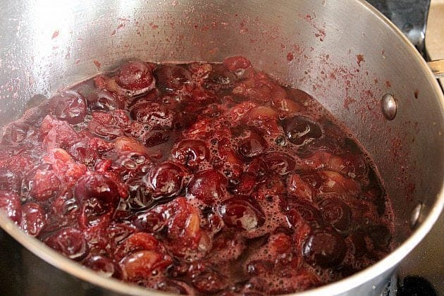 large stockpot with combined cherries, lemon juice and rind with sugar added