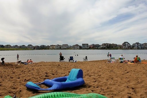 view of the beach with some people having a picnic sitting in the sand