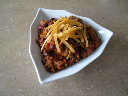 Kitchen Sink Chili in a Triangular White Bowl