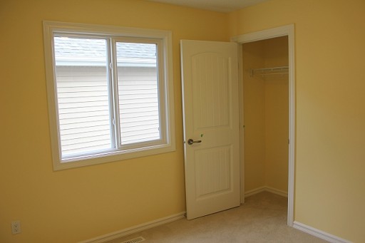 vacant room with white door and light orange paint