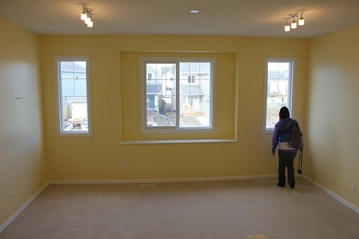 huge space in the house with a lady staring in one of the windows