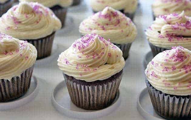 close up of Grape Soda Pop Cupcakes topped with icing and sprinkled with colored sugar