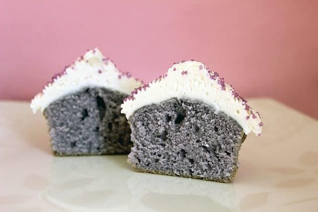 2 pieces of pop cupcakes sliced, showing the purple violet inside of it