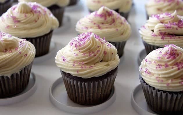 close up of Grape Soda Pop Cupcakes topped with icing and sprinkled with colored sugar