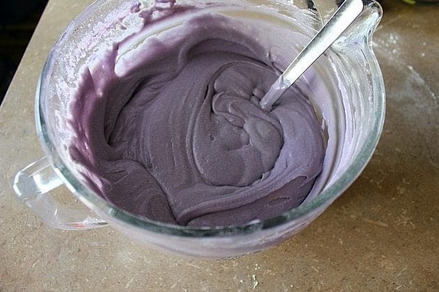 purple colored Cupcake mixture in a Pyrex measuring cup