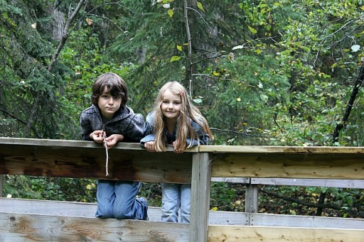 two kids at the wooden bridge