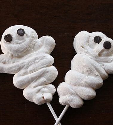 2 pieces ghosts shaped white Meringue Halloween Treats with sticks