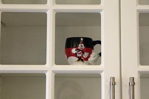 mickey mug inside the new glass cupboards