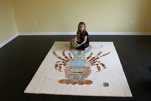 little girl sitting in the carpet holding her baby Bambi Daddy stuff