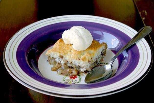 a slice of PEAR COBBLER vanilla ice cream on top on a blue designed plate