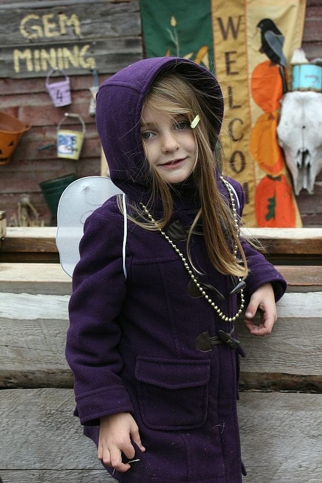 close up of a little girl wearing violet coat