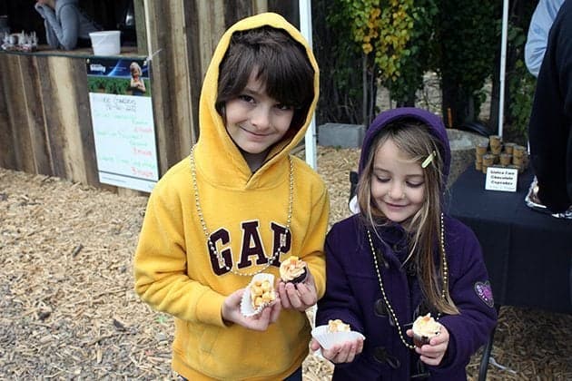 two kids holding chocolate cupcakes and rocky road peabutter cups