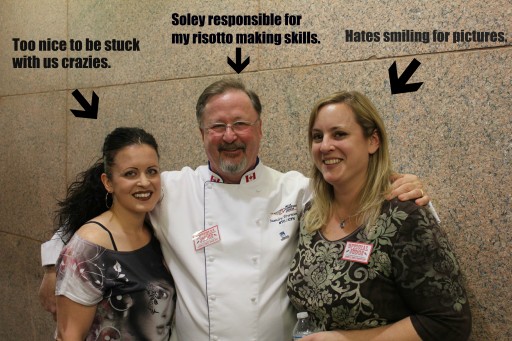 group photo of male chef in his white uniform in the middle of two ladies