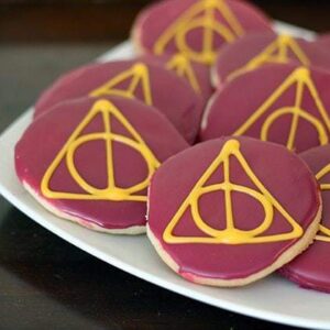 close up pieces of Deathly Hallows Sugar Cookies in white plate