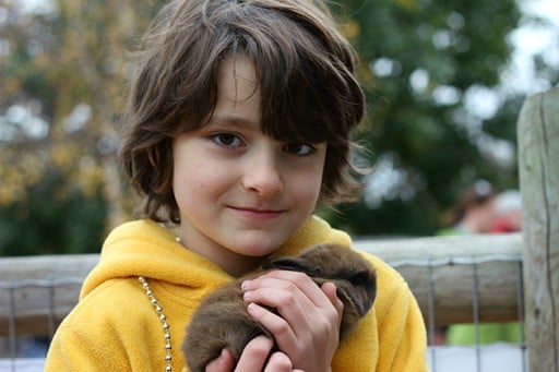 close up of a little boy wearing yellow jacket