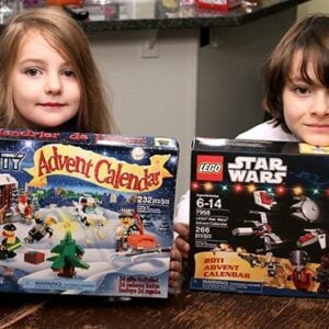 two kids holding their lego boxes