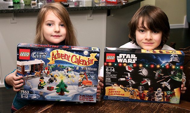 two kids holding their lego boxes