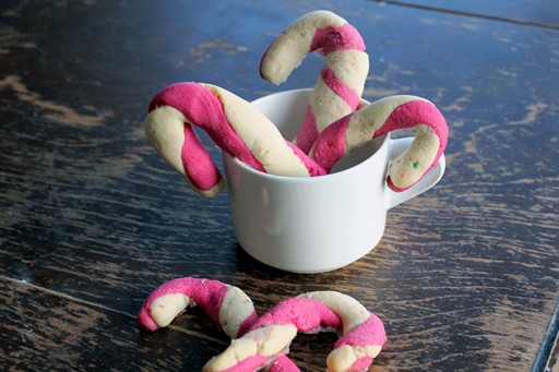 pink white little candy cane breads in a white cup