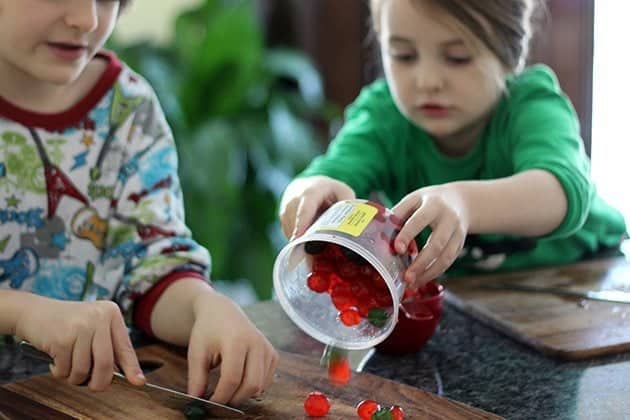 removing candied cherries and pineapple rounds from container