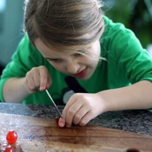 chopping up the candied cherries in a wooden cutting board