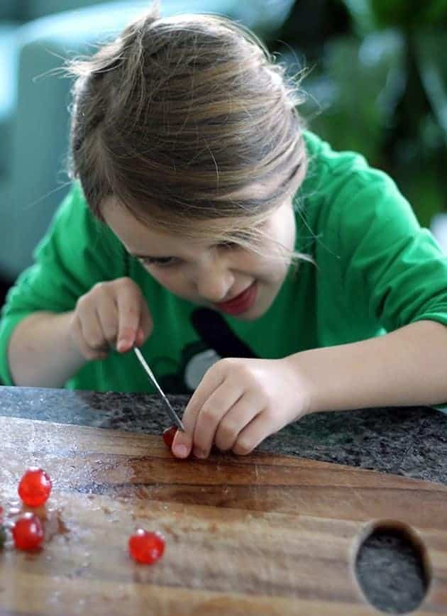 chopping up the candied cherries in a wooden cutting board